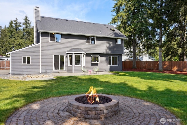 24214 38th Avenue Ct E, Spanaway, WA 98387 - back of property with a fire pit, a patio, and a chimney