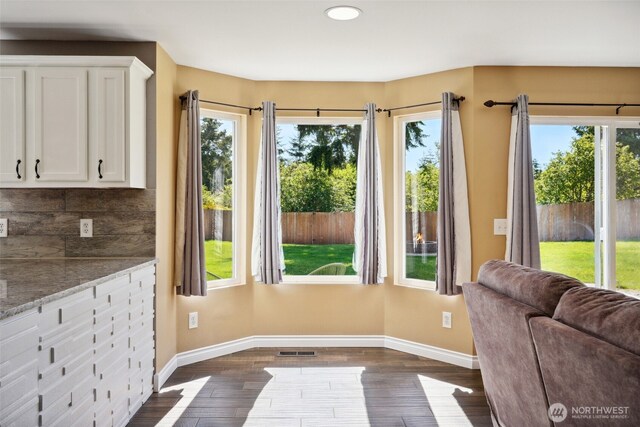 24214 38th Avenue Ct E, Spanaway, WA 98387 - doorway to outside featuring baseboards, dark wood-type flooring, and recessed lighting