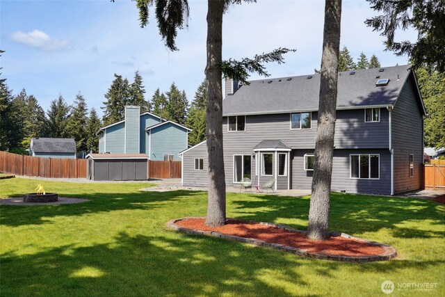 24214 38th Avenue Ct E, Spanaway, WA 98387 - back of property with an outdoor fire pit and a patio