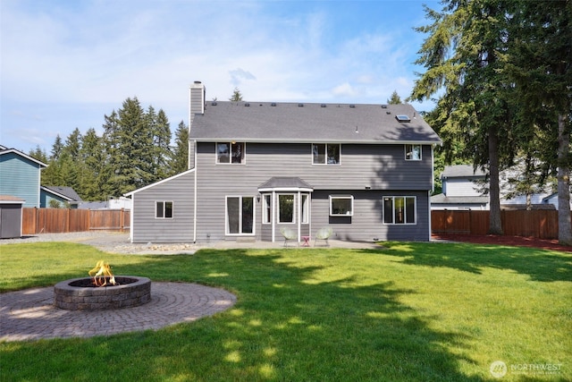 24214 38th Avenue Ct E, Spanaway, WA 98387 - back of property with a fire pit, a chimney, and a patio