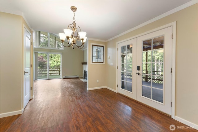 unfurnished dining area featuring baseboards, french doors, wood finished floors, and a chandelier