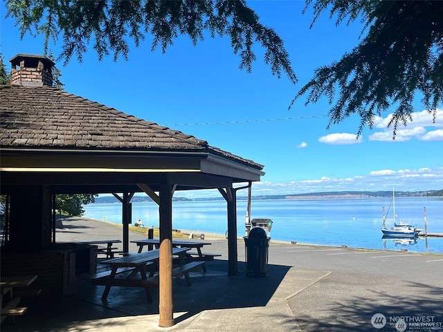 view of dock with a water view and a gazebo