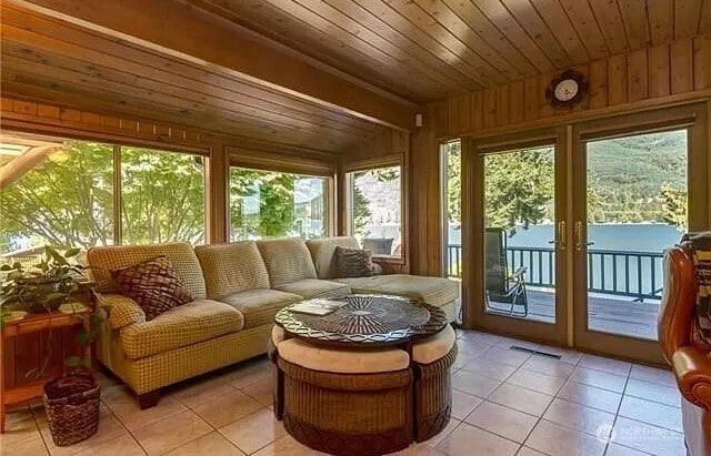 486 W Lake Samish Dr, Bellingham, WA 98229 - sunroom / solarium featuring tile patterned flooring, french doors, wooden ceiling, healthy amount of natural light, and wooden walls