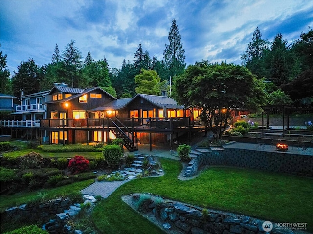 486 W Lake Samish Dr, Bellingham, WA 98229 - rear view of property with stairway, a deck, a lawn, and metal roof