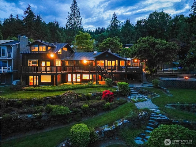 486 W Lake Samish Dr, Bellingham, WA 98229 - rear view of property with stairs, a yard, a deck, a standing seam roof, and metal roof