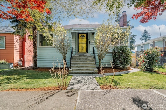 6654 Flora Ave S, Seattle, WA 98108 - view of front of house with a chimney and a front lawn
