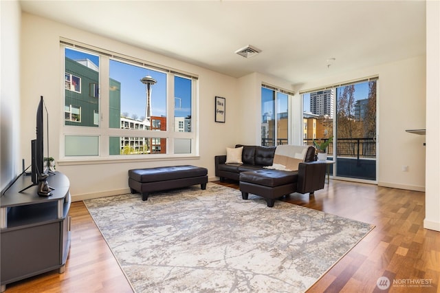3104 Western Ave Unit 603, Seattle, WA 98121 - living area with visible vents, baseboards, and wood finished floors