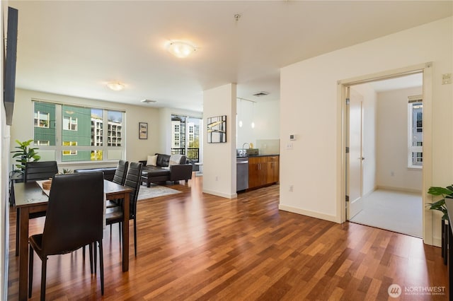 3104 Western Ave Unit 603, Seattle, WA 98121 - dining area with visible vents, baseboards, and wood finished floors