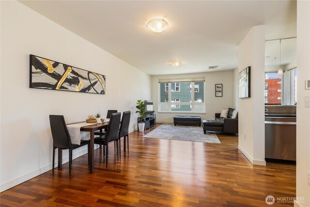 3104 Western Ave Unit 603, Seattle, WA 98121 - dining area with wood finished floors, baseboards, and visible vents