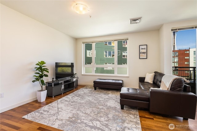 3104 Western Ave Unit 603, Seattle, WA 98121 - living room with plenty of natural light, baseboards, and wood finished floors