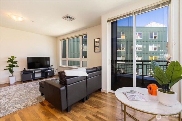 3104 Western Ave Unit 603, Seattle, WA 98121 - living area featuring visible vents, baseboards, and wood finished floors