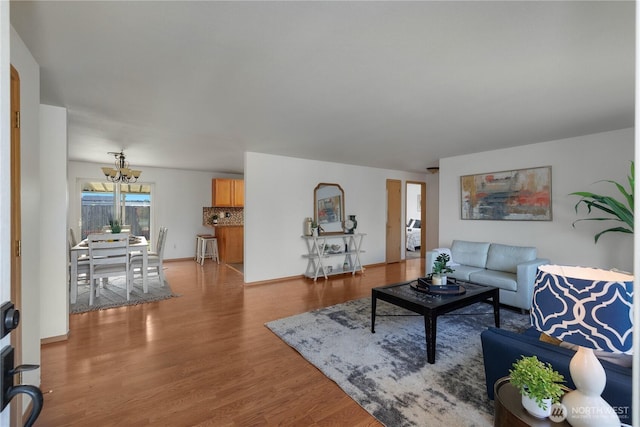 living area with wood finished floors and a notable chandelier