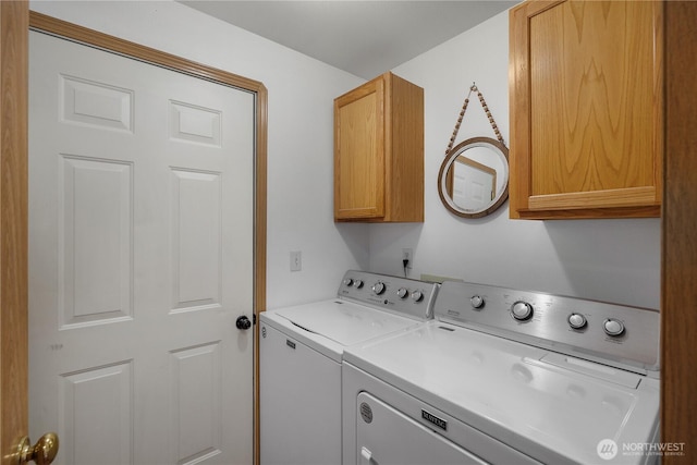 washroom featuring cabinet space and washer and dryer
