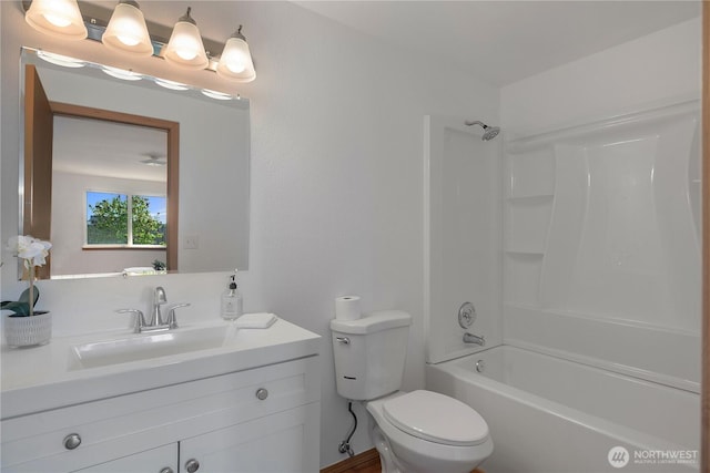 bathroom featuring toilet, bathing tub / shower combination, and vanity