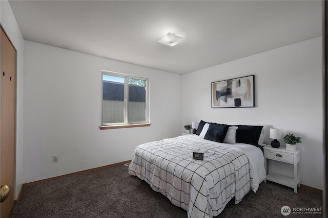 bedroom featuring baseboards and carpet