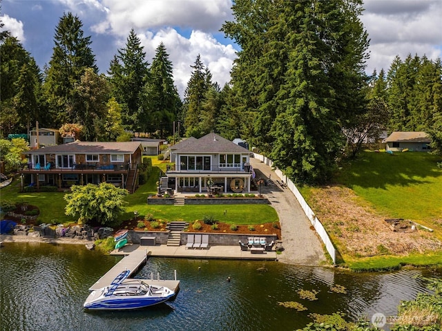 back of house featuring a yard, stairs, and a deck with water view