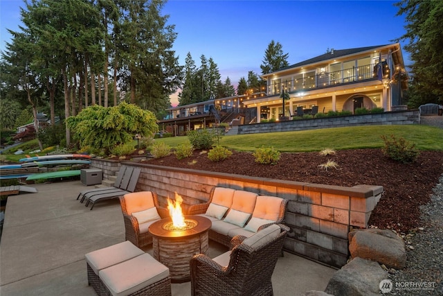 view of patio / terrace featuring a fire pit and a balcony