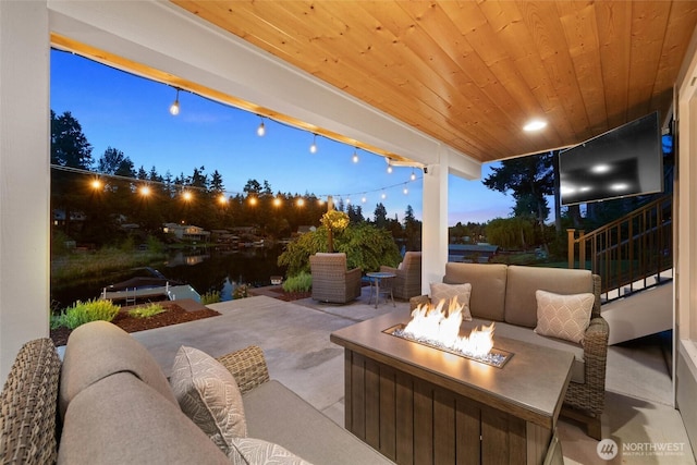 view of patio featuring an outdoor living space with a fire pit