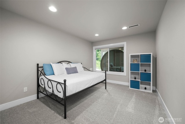 carpeted bedroom featuring baseboards and recessed lighting