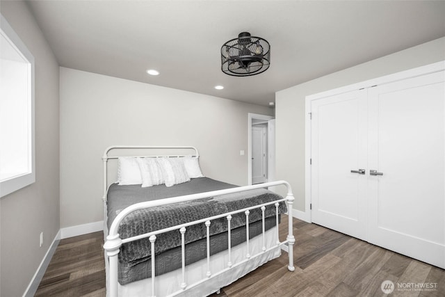 bedroom featuring wood finished floors, recessed lighting, and baseboards