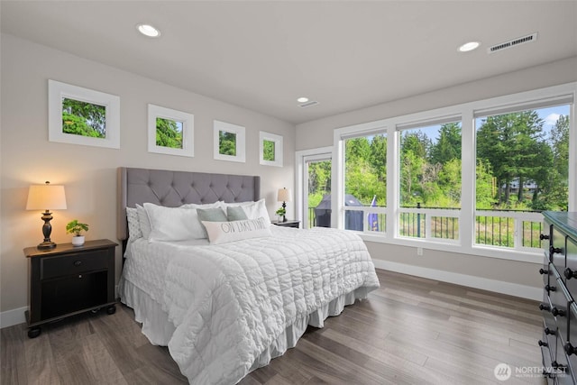 bedroom with baseboards, multiple windows, recessed lighting, and dark wood-style floors