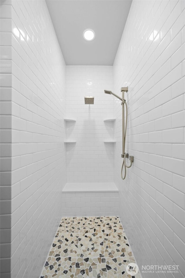 bathroom featuring a tile shower and recessed lighting