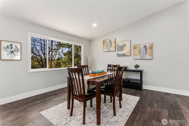 dining room with wood finished floors, vaulted ceiling, baseboards, and recessed lighting