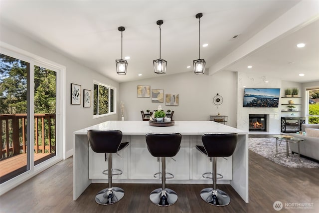 kitchen featuring a kitchen island, dark wood-type flooring, light countertops, and recessed lighting