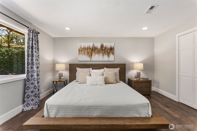 bedroom with baseboards, dark wood-type flooring, and visible vents
