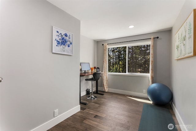 exercise room featuring baseboards, wood finished floors, and recessed lighting