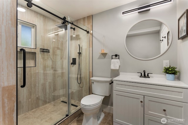 full bath featuring vanity, tile patterned flooring, a shower stall, and toilet