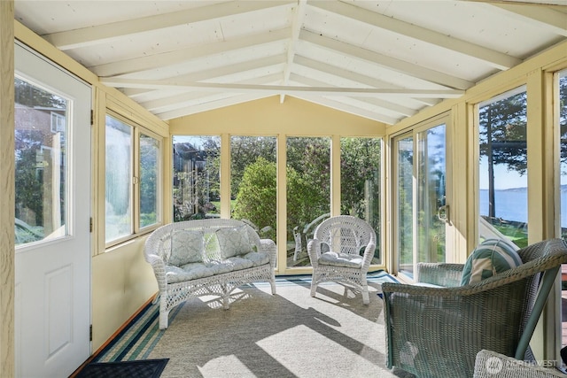 sunroom with plenty of natural light and beam ceiling