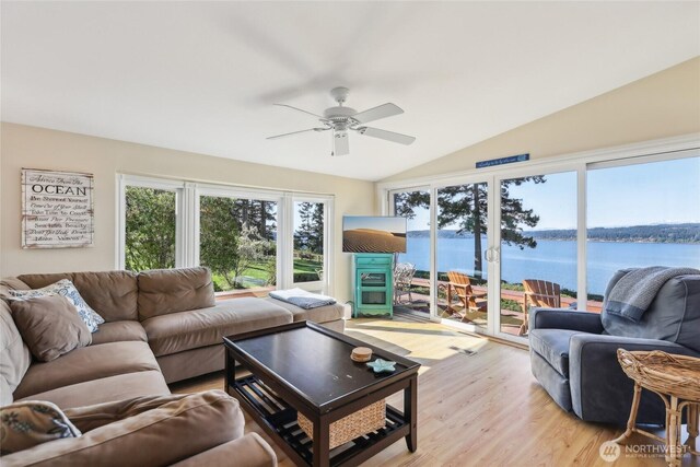 living room featuring vaulted ceiling, a ceiling fan, and light wood finished floors