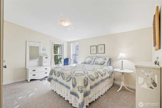 bedroom featuring baseboards, carpet flooring, and vaulted ceiling