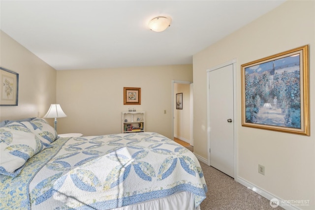bedroom with baseboards and carpet