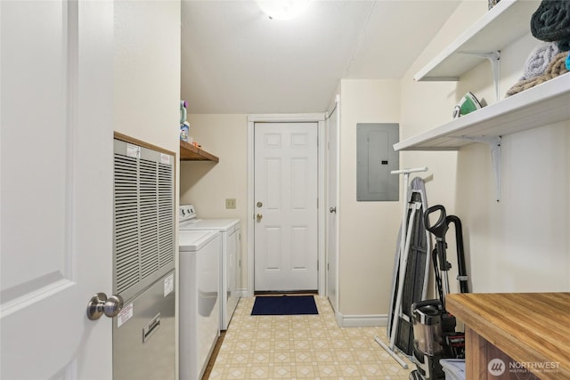 laundry area featuring electric panel, baseboards, separate washer and dryer, light floors, and laundry area