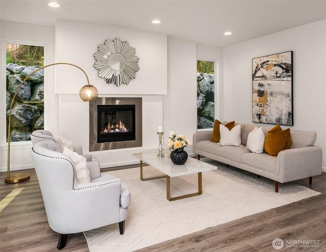 16515 26th St E, Lake Tapps, WA 98391 - living area featuring a glass covered fireplace, wood finished floors, recessed lighting, and baseboards