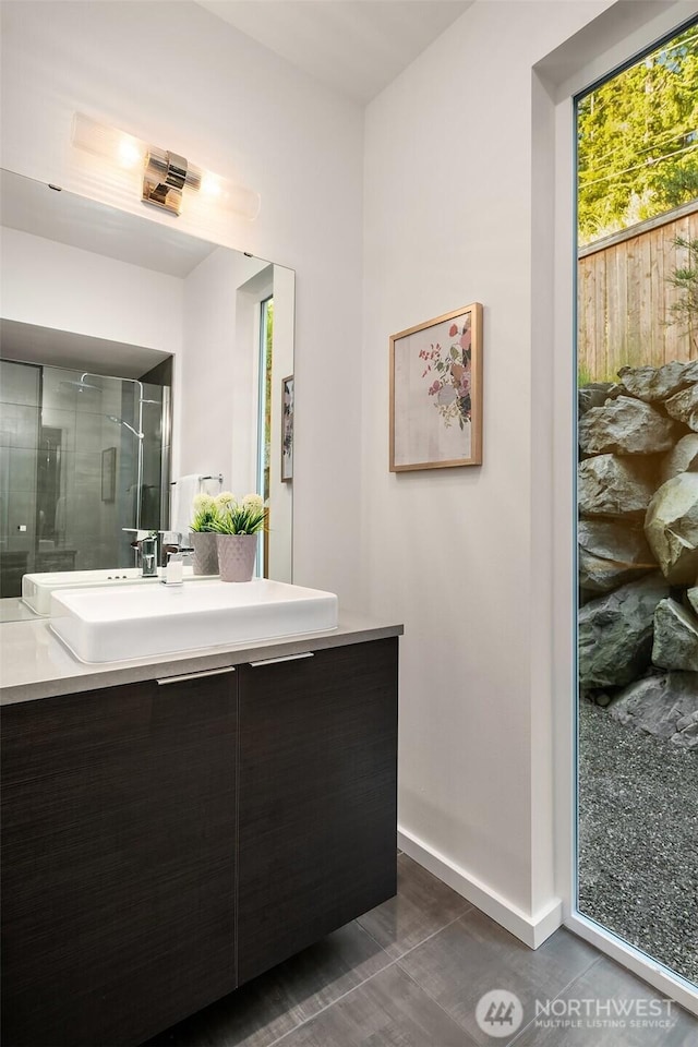 16515 26th St E, Lake Tapps, WA 98391 - full bathroom featuring vanity, baseboards, and a shower with shower door