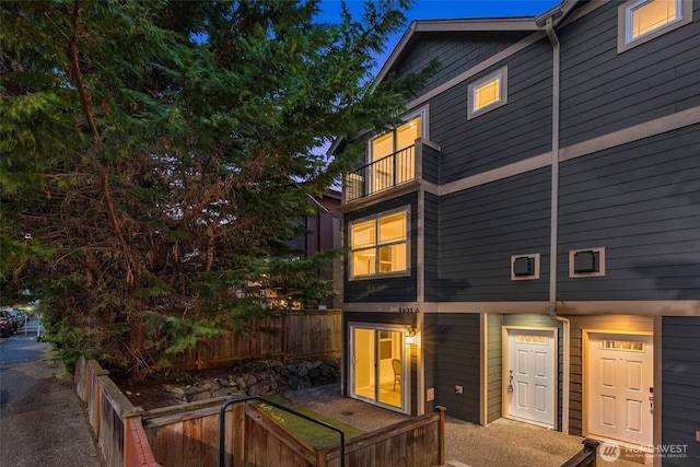 5235 11th Ave NE Unit A, Seattle, WA 98105 - back of property with a balcony and fence