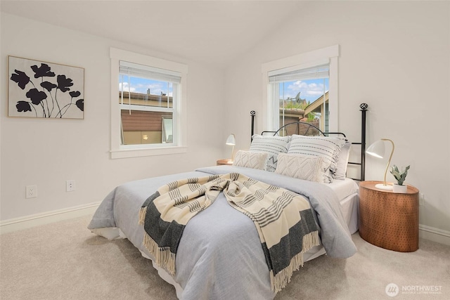 5235 11th Ave NE Unit A, Seattle, WA 98105 - bedroom featuring multiple windows, carpet, vaulted ceiling, and baseboards
