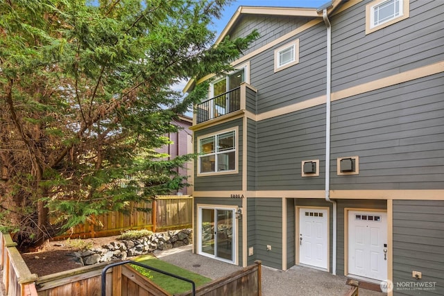 5235 11th Ave NE Unit A, Seattle, WA 98105 - rear view of house featuring a balcony and fence