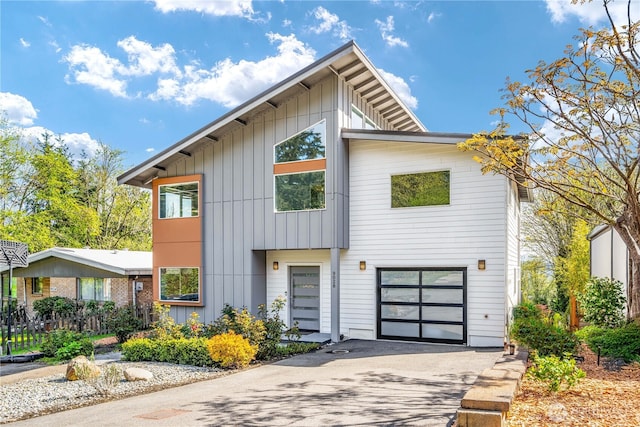 9028 45th Ave NE, Seattle, WA 98115 - view of front of home with a garage, board and batten siding, and aphalt driveway