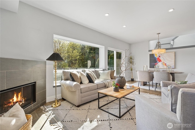 9028 45th Ave NE, Seattle, WA 98115 - living room with recessed lighting, wood finished floors, a tiled fireplace, and baseboards