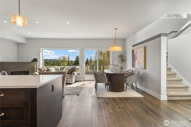 9028 45th Ave NE, Seattle, WA 98115 - dining space featuring a tile fireplace, baseboards, wood finished floors, and recessed lighting