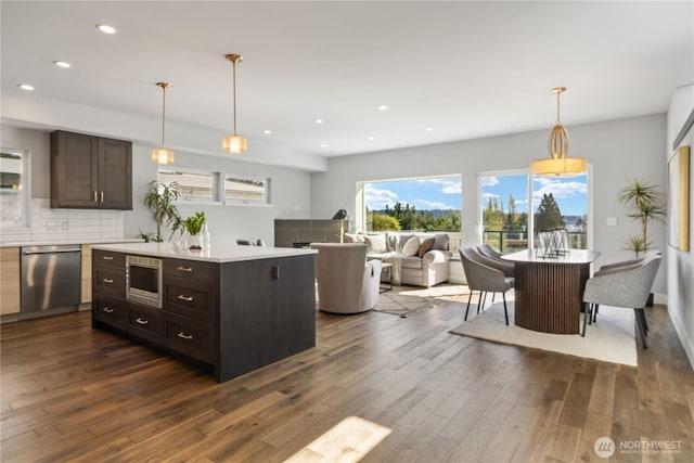9028 45th Ave NE, Seattle, WA 98115 - kitchen featuring recessed lighting, stainless steel appliances, light countertops, dark brown cabinets, and dark wood-type flooring