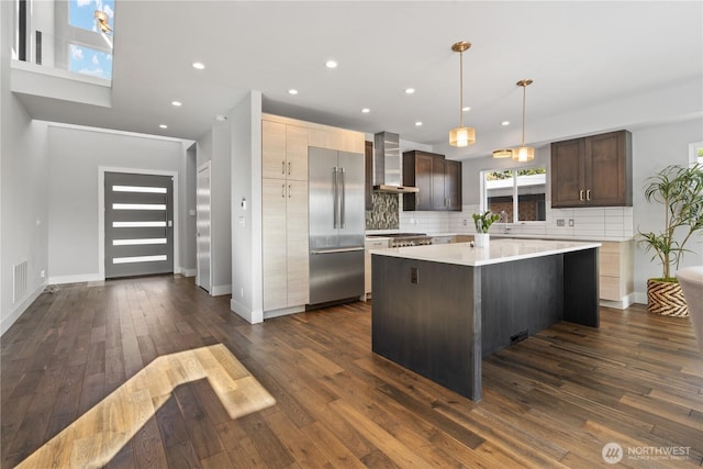 9028 45th Ave NE, Seattle, WA 98115 - kitchen with wall chimney range hood, high end refrigerator, a center island, decorative backsplash, and light countertops