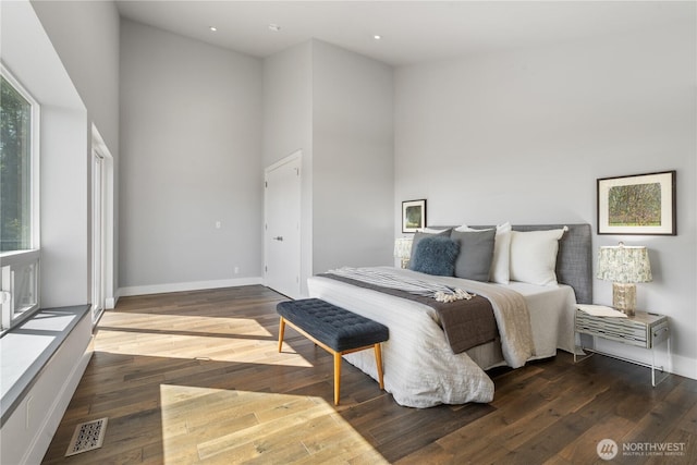 9028 45th Ave NE, Seattle, WA 98115 - bedroom with baseboards, wood finished floors, a towering ceiling, and visible vents