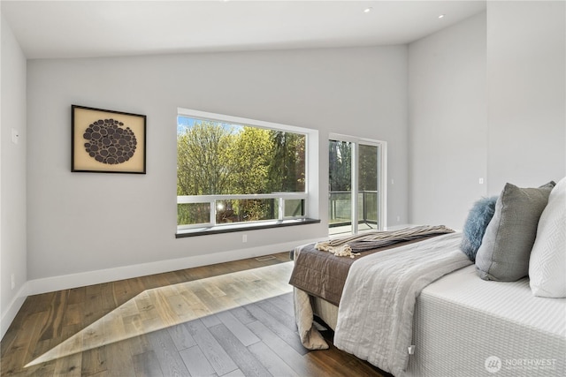9028 45th Ave NE, Seattle, WA 98115 - bedroom featuring high vaulted ceiling, baseboards, wood finished floors, and access to exterior