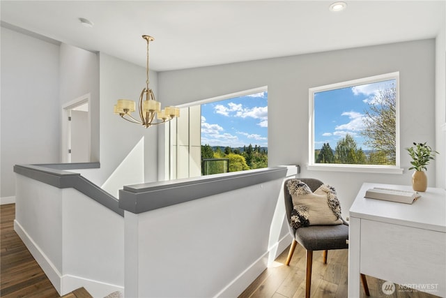 9028 45th Ave NE, Seattle, WA 98115 - interior space with baseboards, dark wood-style floors, a notable chandelier, and an upstairs landing