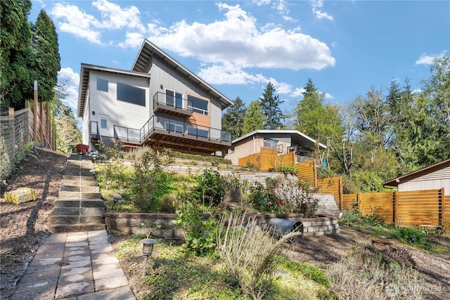 9028 45th Ave NE, Seattle, WA 98115 - back of house with board and batten siding, stairs, and fence